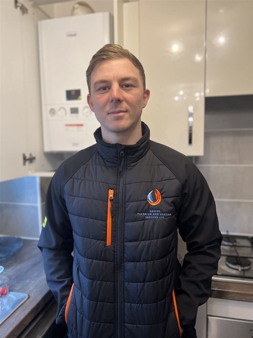 Gastek engineer in a branded jacket in a customer's kitchen