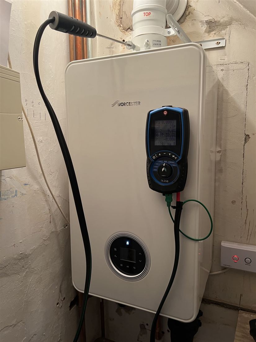 New boiler on the wall with a flue gas analyser plugged in